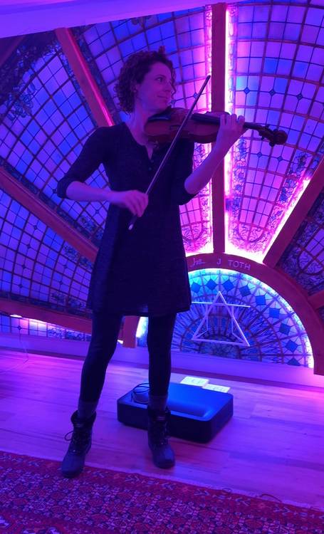 Ariel Karas plays violin in Jason Toth's studio listening room at 78th Street Studios.